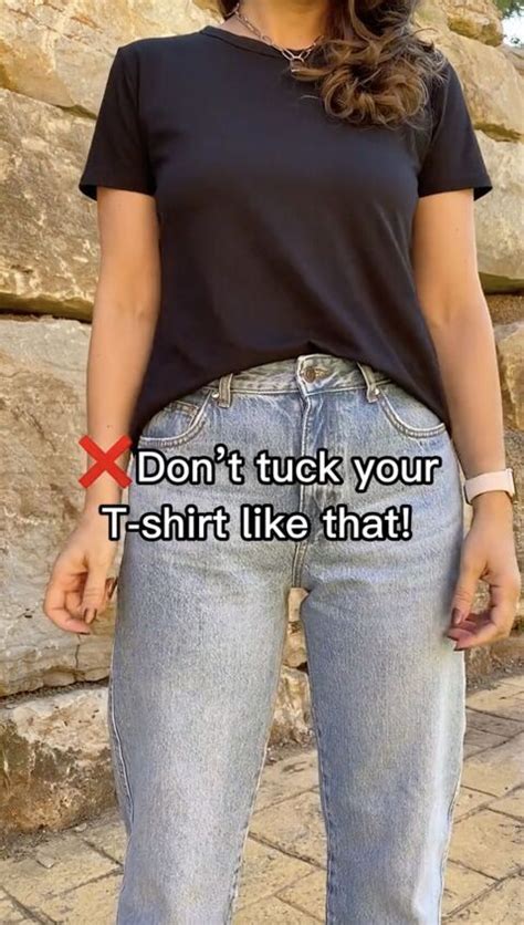 tucking shirt into jeans female.